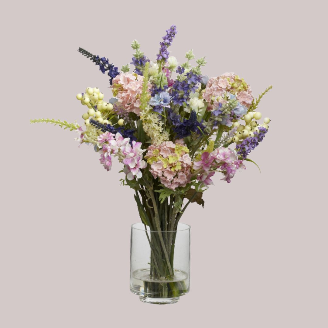 Artificial lavender & hydrangea arrangement in a clear vase with a water illusion & combined height of 16 inches