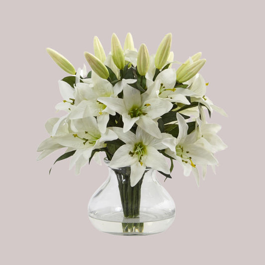 Artificial white lily arrangement in a clear vase with a lifelike water illusion and a combined height of 13.5 inches