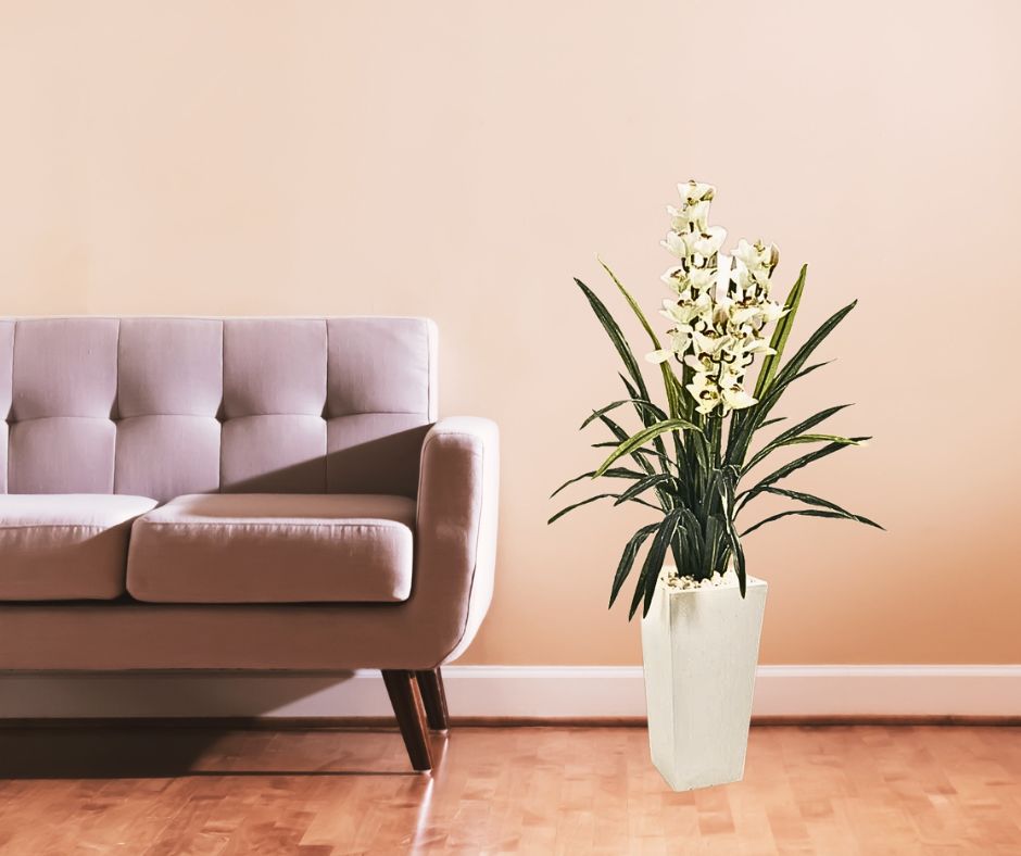 Artificial white orchid cymbidium arrangement in a tall white tower planter with a combined height of 4 feet 5 inches set in a calm living space 