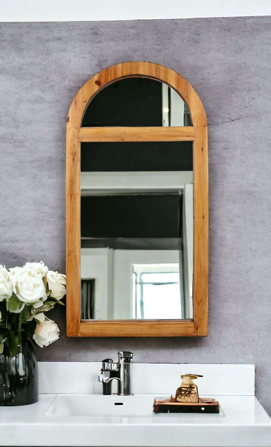 Wood frame arched accent mirror with half moon mirror on top and rectangular mirror below separated by wood piece hanging above a bathroom sink