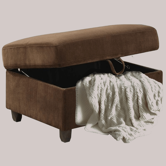 Chocolate velvet ottoman with hinged storage lid. White throw blanket protruding from storage.