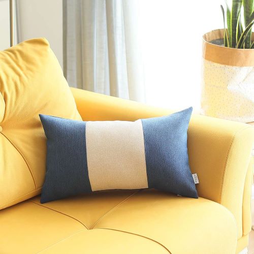 Polyester blue lumbar pillow with a white midsection set on a couch