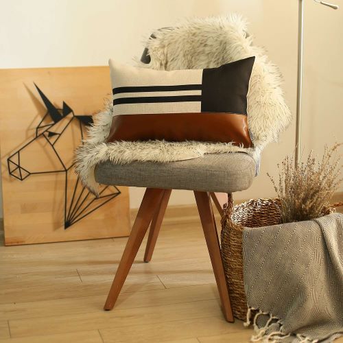 Polyester and mix faux leather brown and black geometric lumbar pillow set on a wooden chair