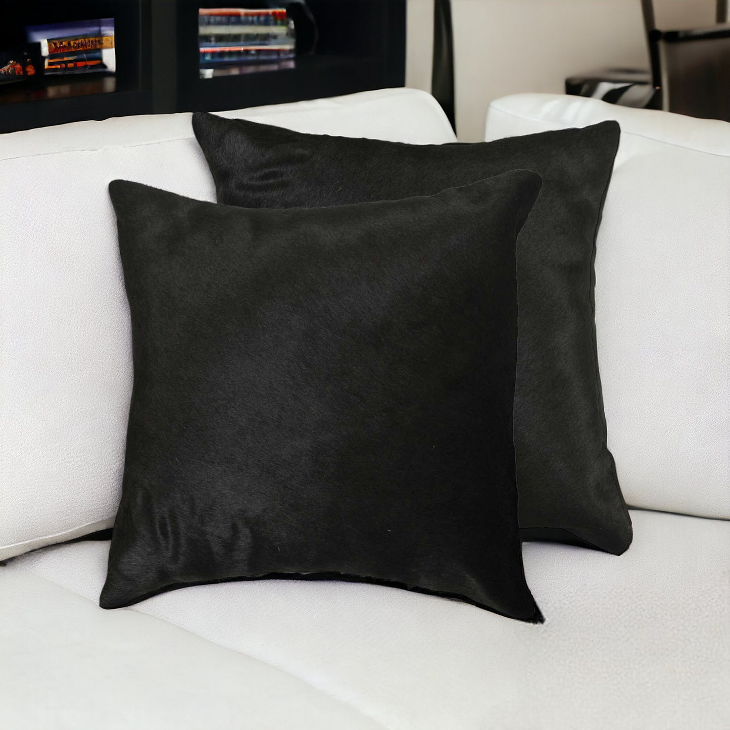 two solid black cowhide 18" throw pillows