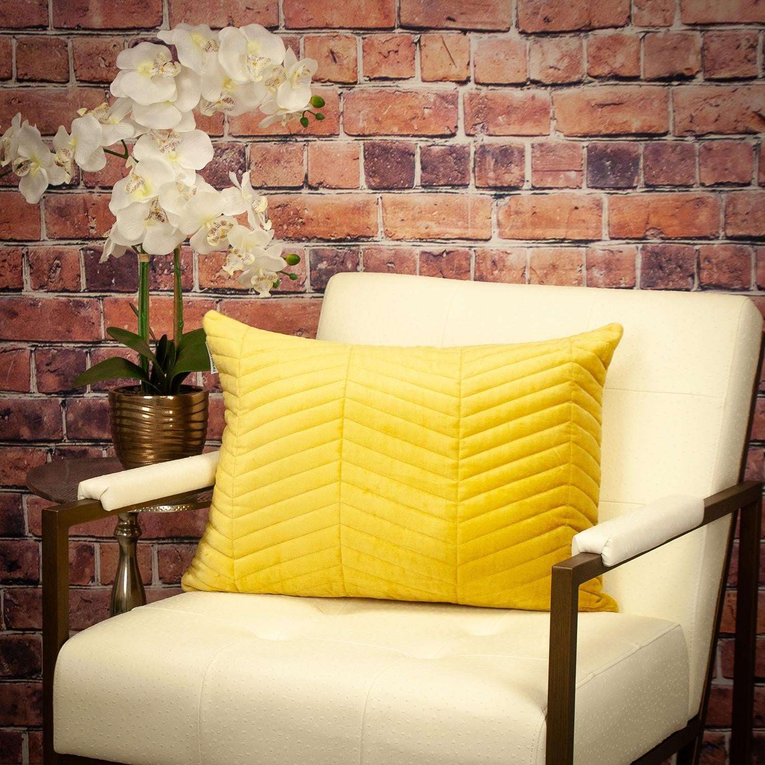 Yellow quilted chevron pattern lumbar throw pillow on chair