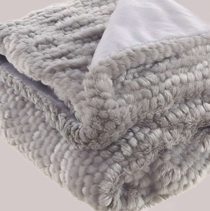 Gray knitted throw blanket folded