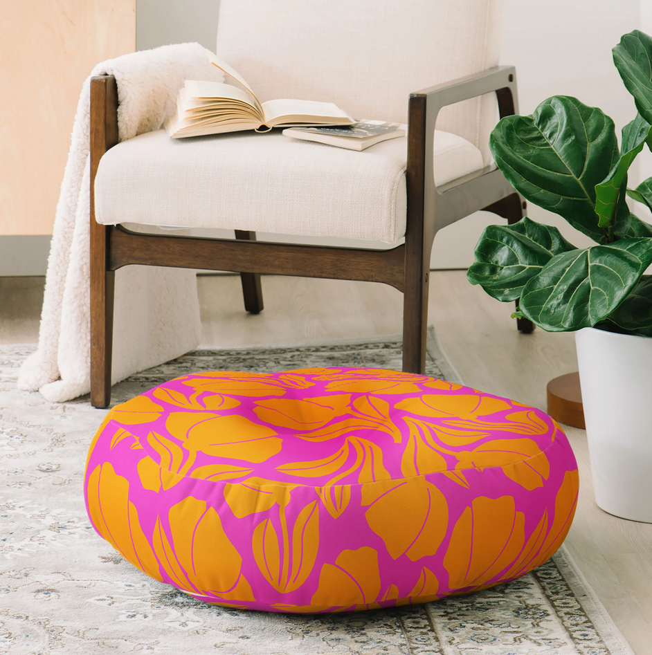 Round floor pillow with yellow blooms on fuchsia base color